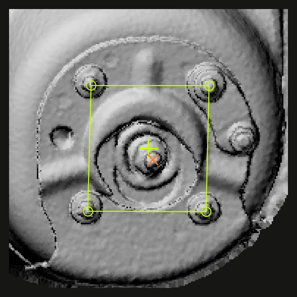 Top view of a strut mount with its four-stud pattern and centre marked